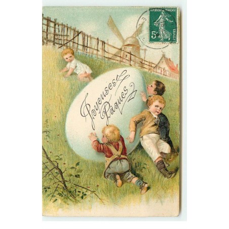 n°16539 - Carte Gaufrée - Joyeuses Pâques - Garçon poussant un oeuf sur une colline, au fond un moulin à vent